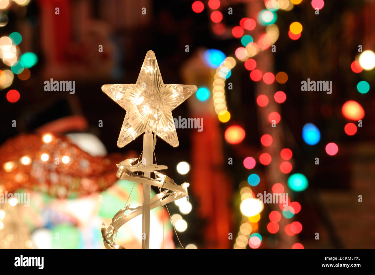 Christmas Lights Background. Nativity star, blurred lights and outdoor decorations Stock Photo