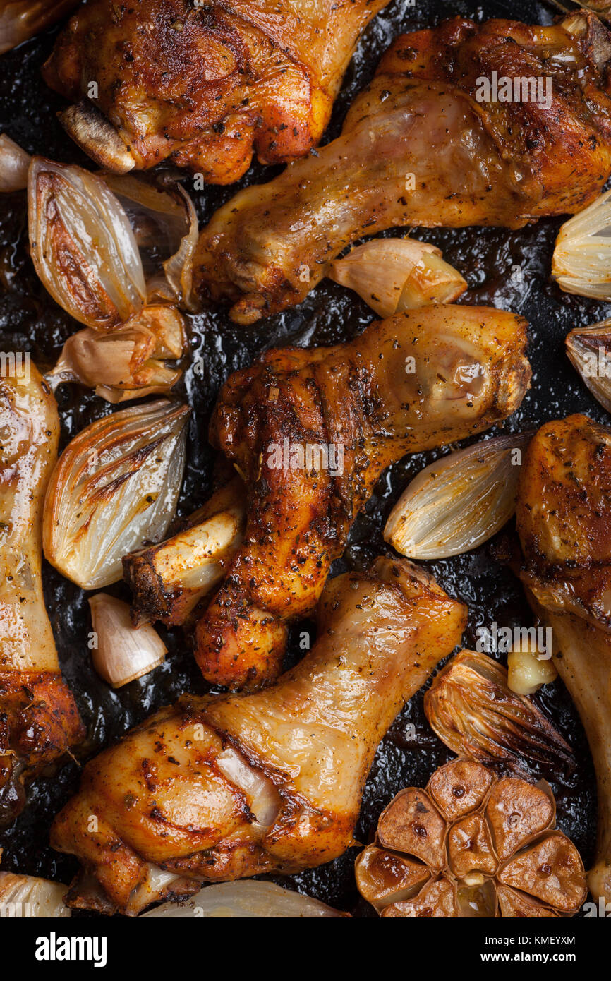 Ovenbaked chicken leg quarters with onion, garlic and capsicum on a