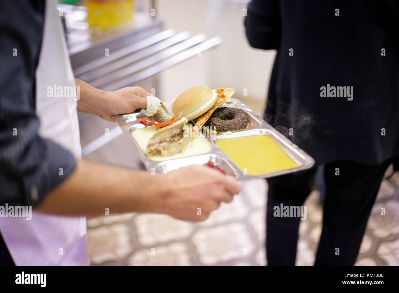 A person is having lunch at a cafeteria for poor people Stock Photo