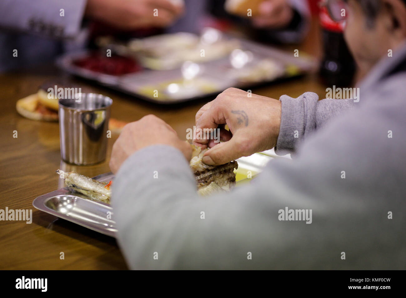 A person is having lunch at a cafeteria for poor people Stock Photo
