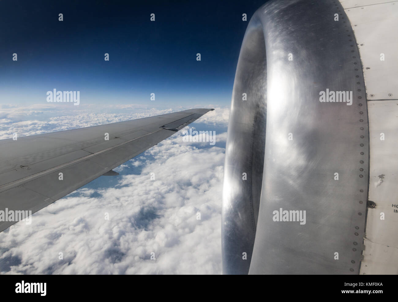 airplane engine and wing seen in flight Stock Photo