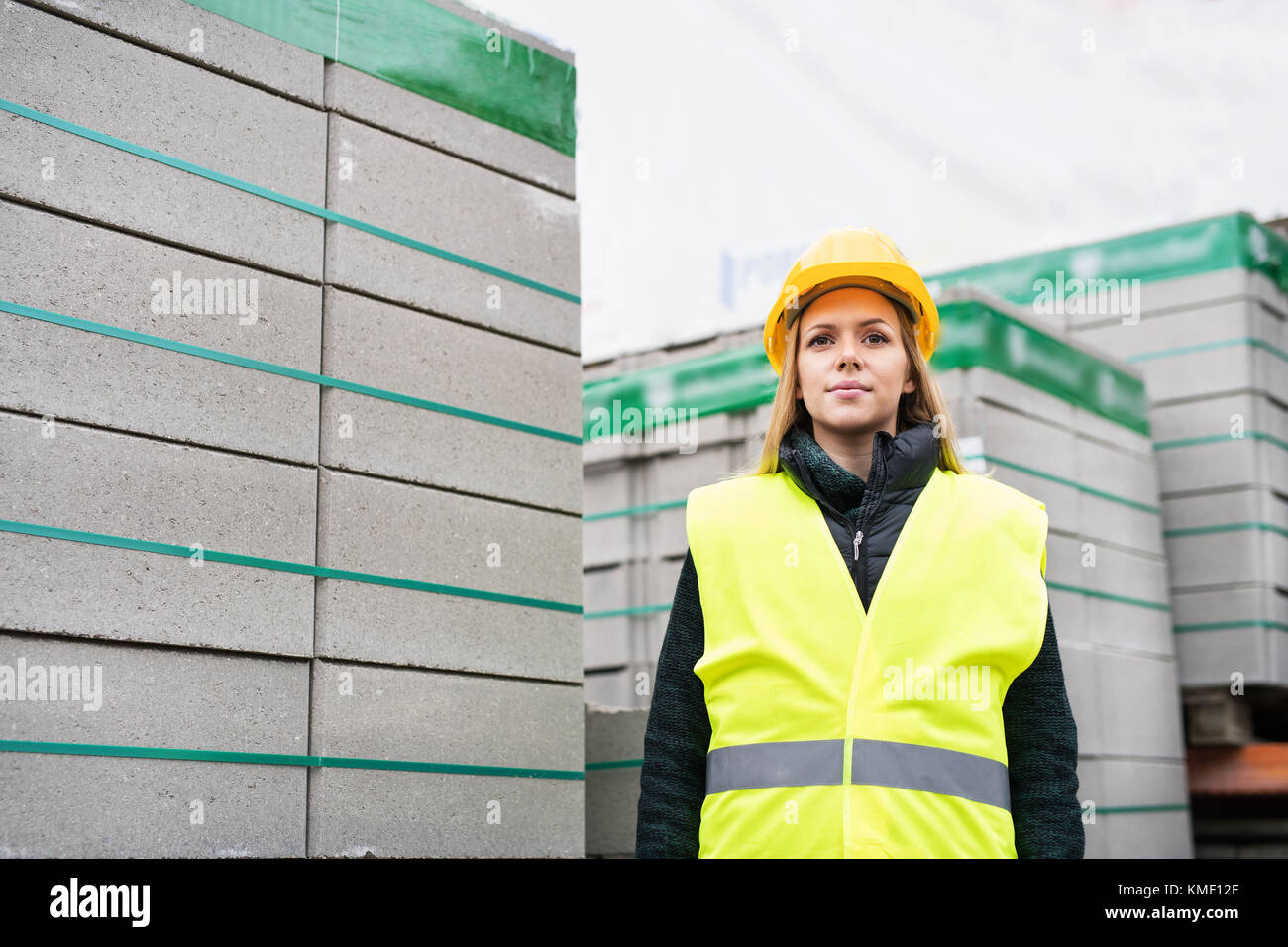 Woman worker standing in an industrial area. Stock Photo