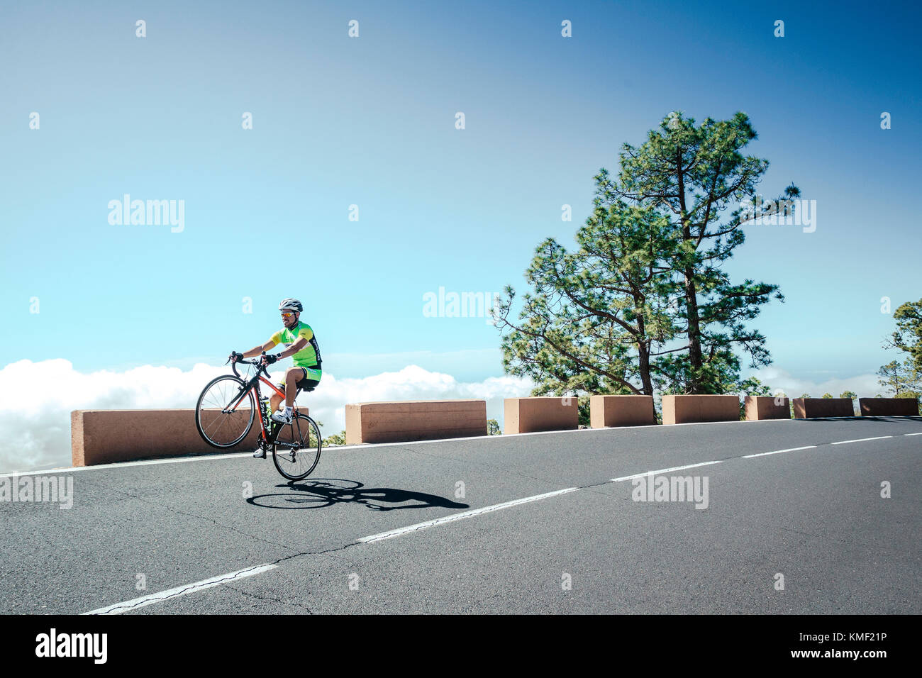 Road cyclist doing wheelie,Tenerife,Canary Islands,Spain Stock Photo