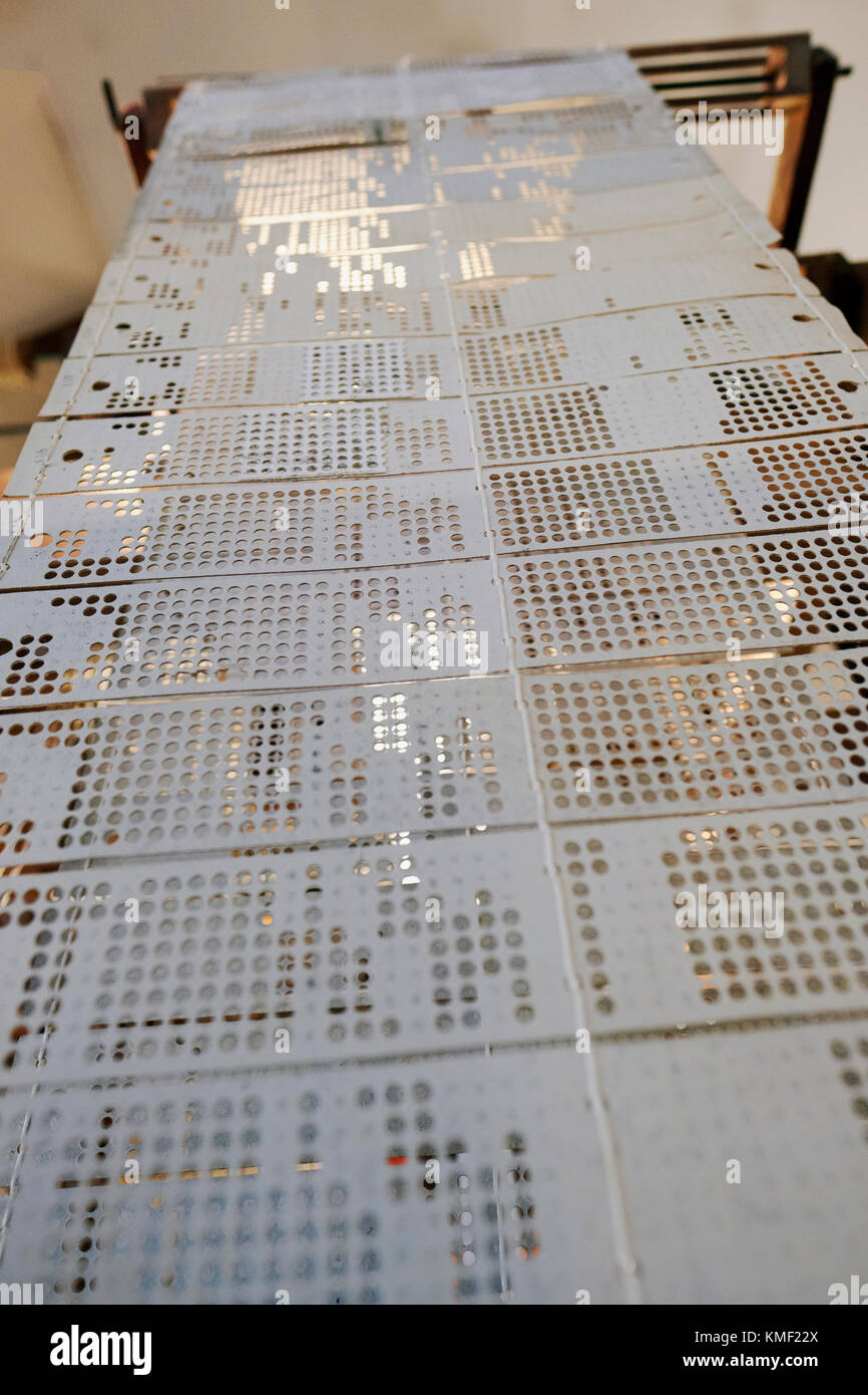 Looking up the line of punch cards of a 19th century Jacquard Textile Loom Stock Photo