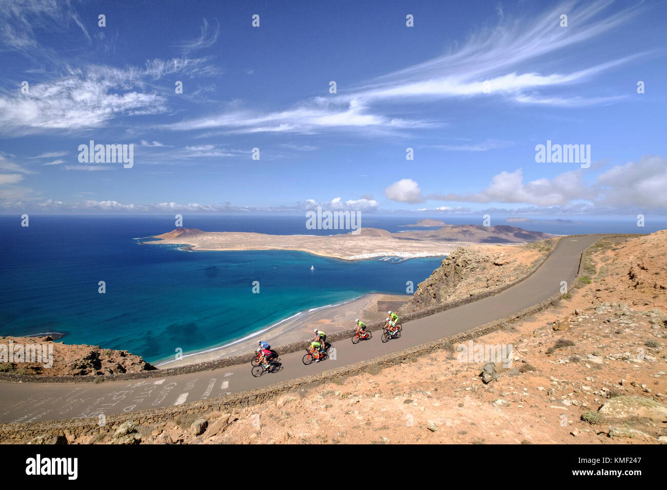 Group of cyclists pedaling on coastal road,Lanzarote,Canary Islands,Spain Stock Photo