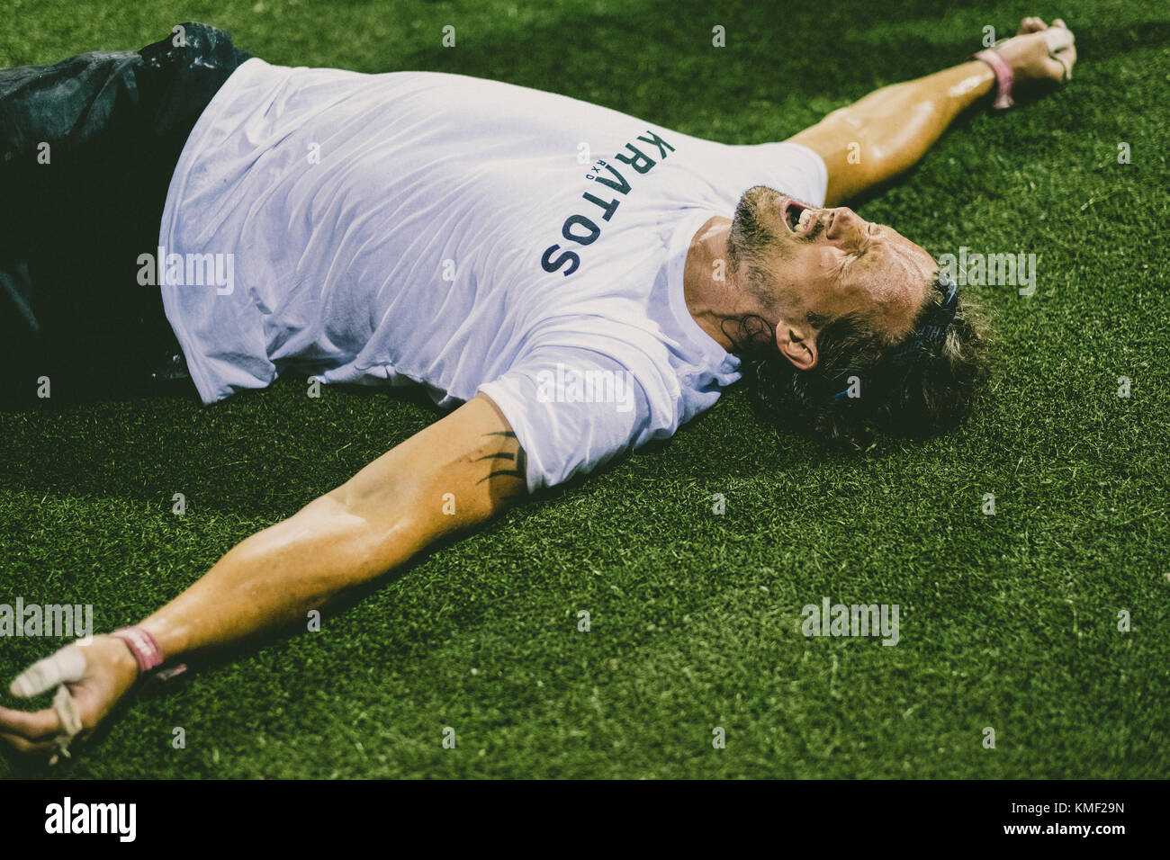 Exhausted athlete lying on grass,Tenerife,Canary Islands,Spain Stock Photo