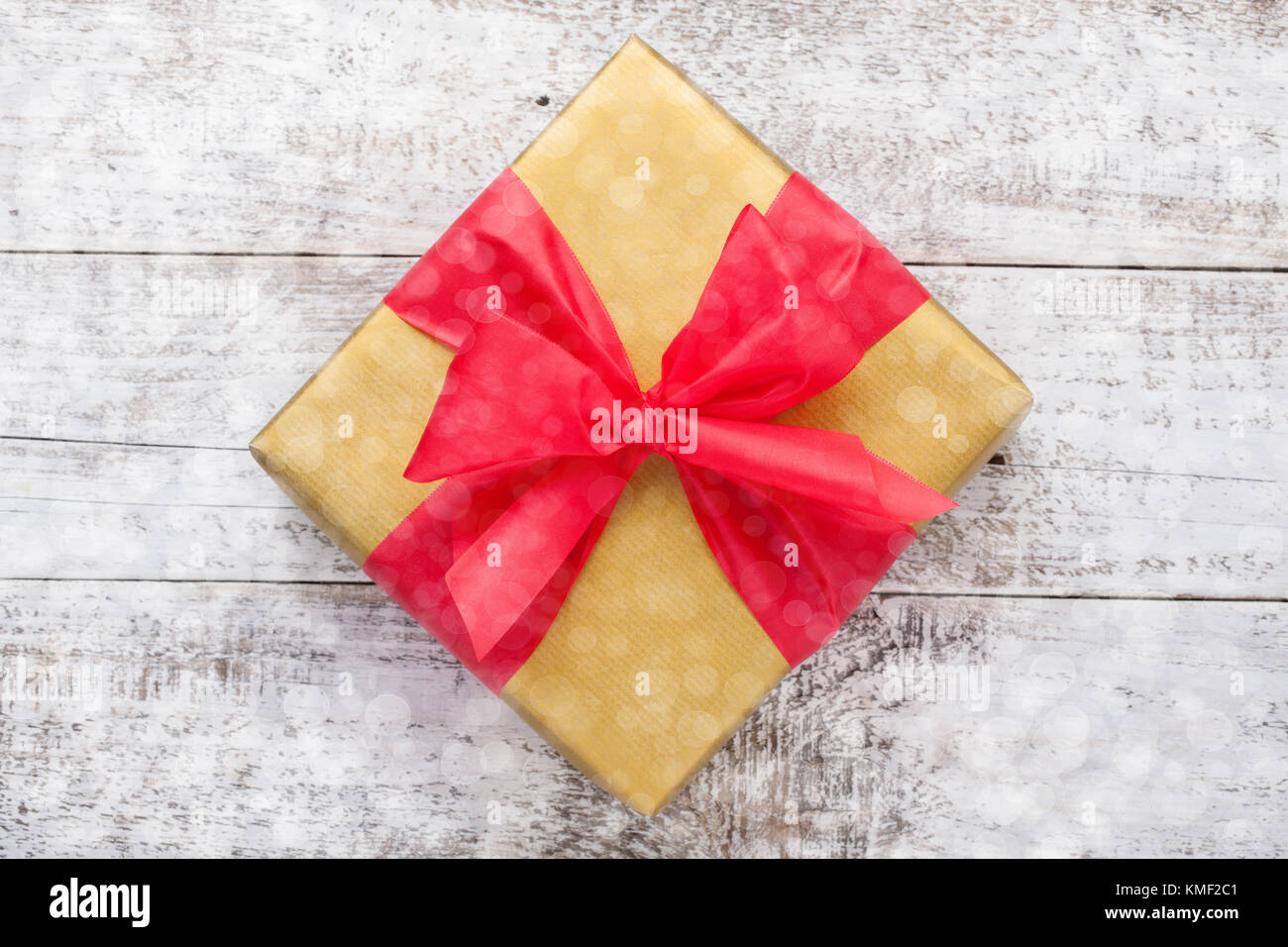 Golden gift box tied with a red ribbon isolated on white background ...