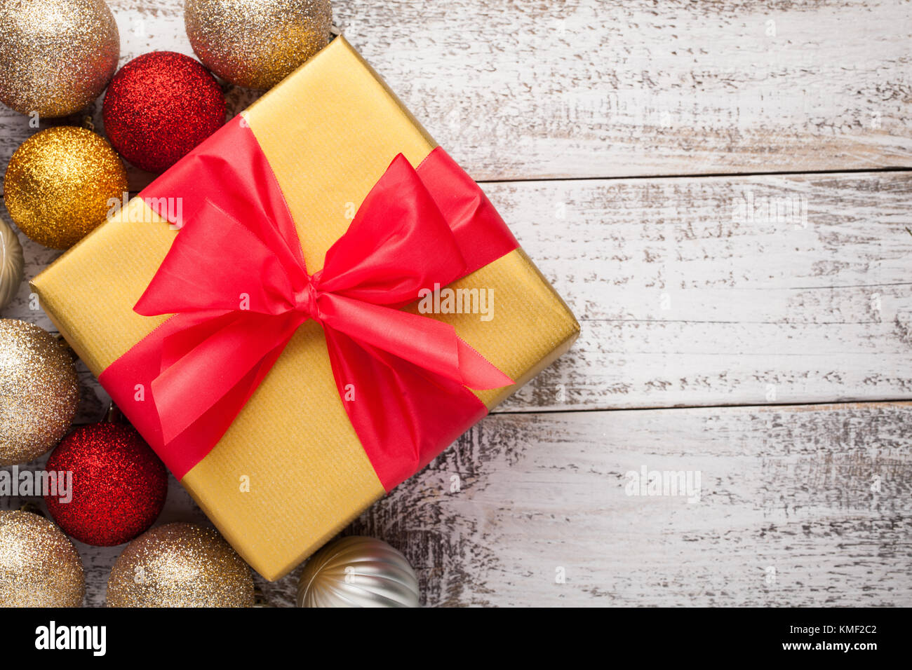 Golden gift box tied with a red ribbon isolated on white background ...