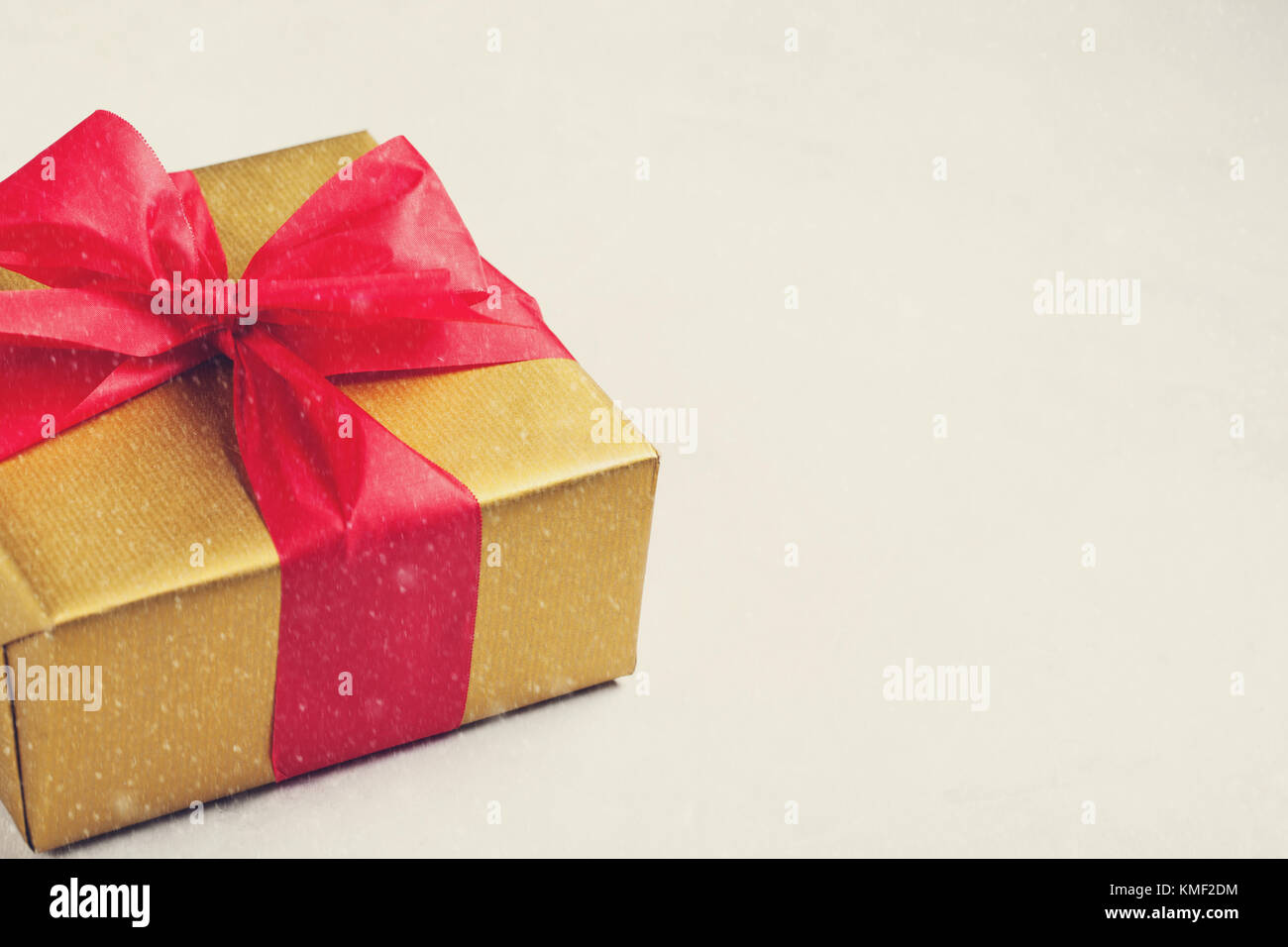 Golden gift box tied with a red ribbon isolated on white background ...