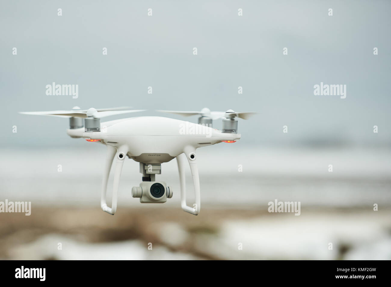 Minsk, Belarus - December 3, 2017: DJI phantom 4 pro drone fly at winter gray sky in low heaght Stock Photo