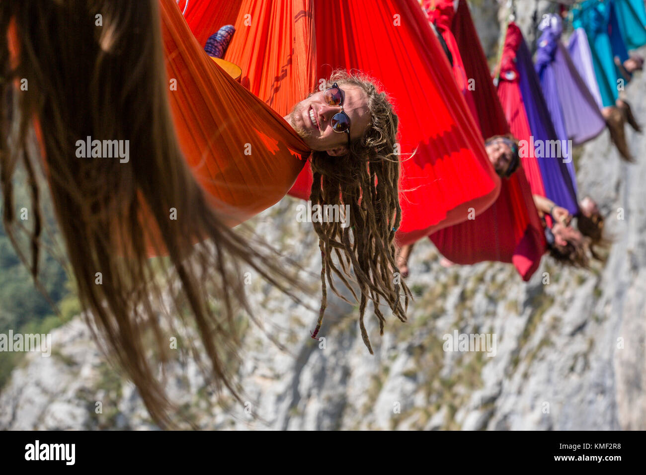 Side view of people lying in hammocks above mountains,Tijesno Canyon