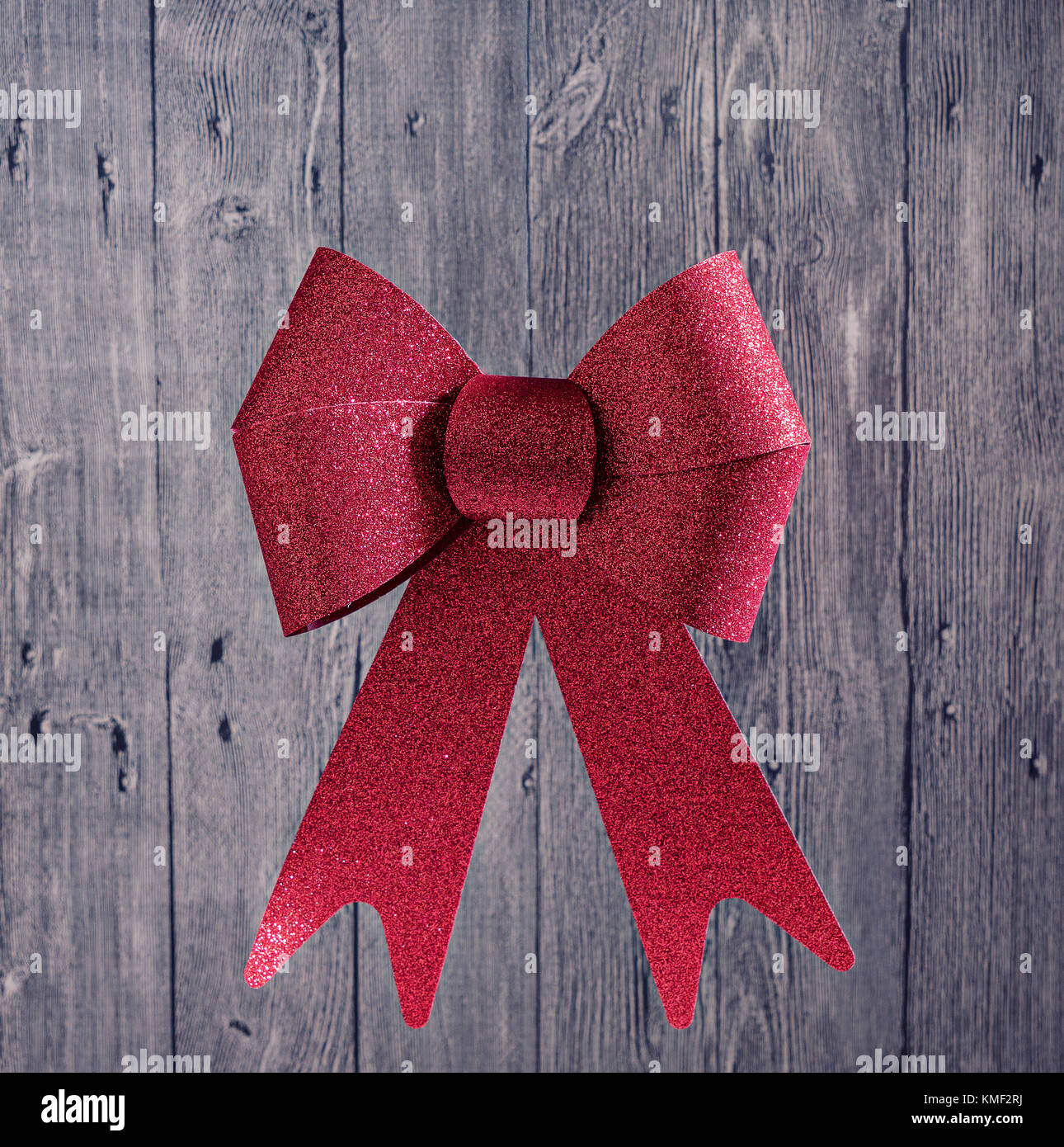 Big Red Christmas Shiny Bow Ribbon on a Wooden Rustic Background ...