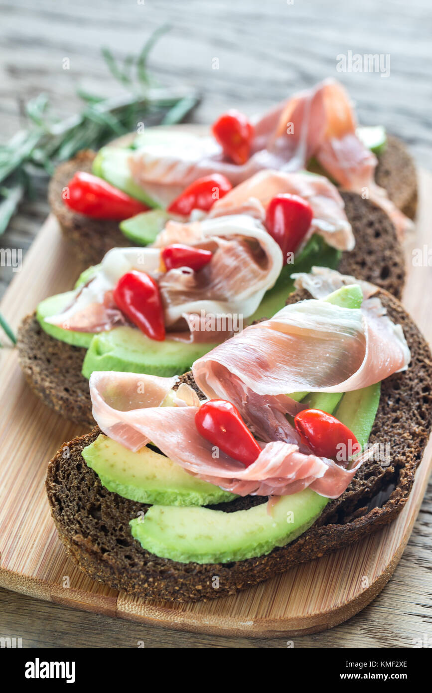 Sandwiches with avocado and prosciutto Stock Photo Alamy
