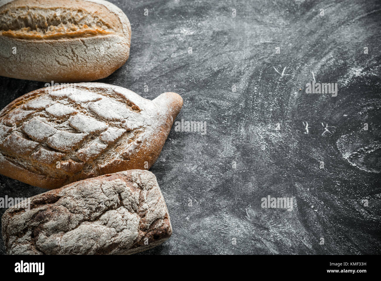 Whole grain breads on the dark wooden background Stock Photo - Alamy