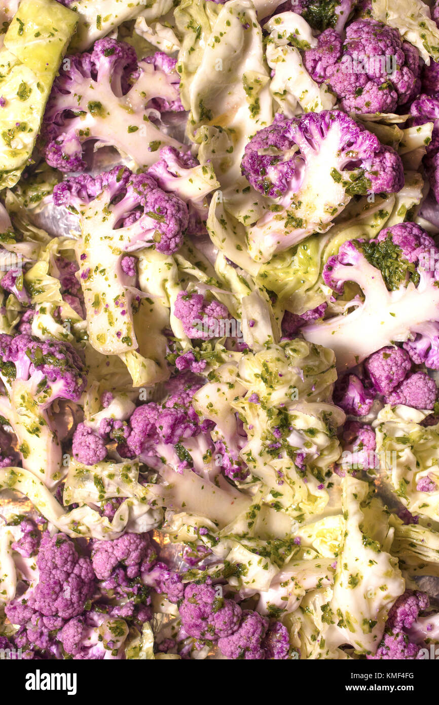 Colorful raw purple cauliflower and green cabbage ready for oven roasting Stock Photo