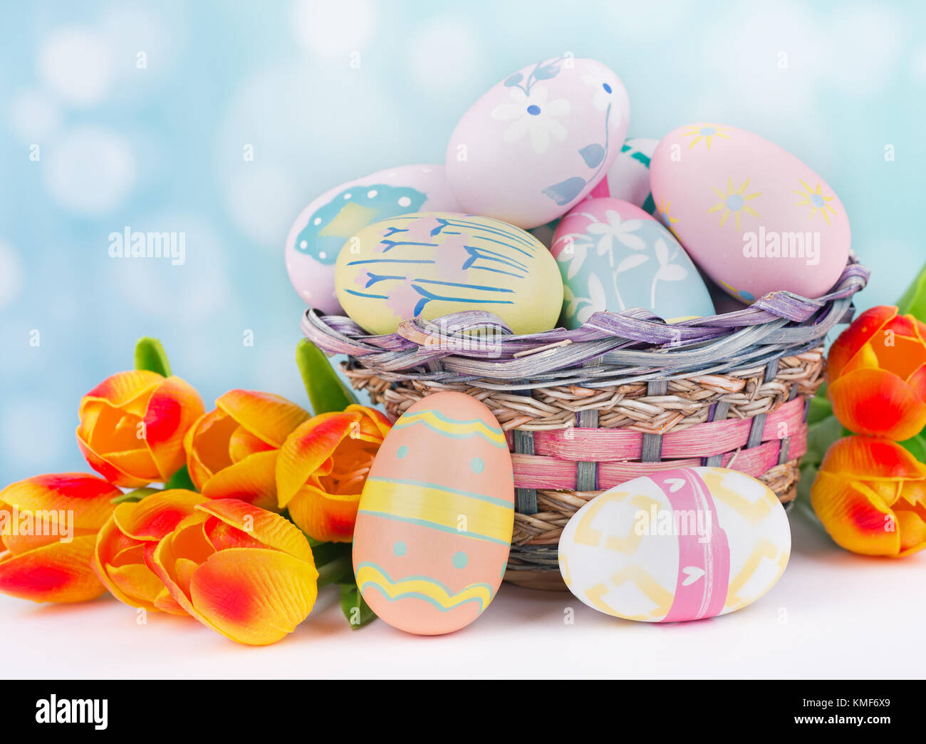 Easter eggs and tulips on a colorful background Stock Photo - Alamy