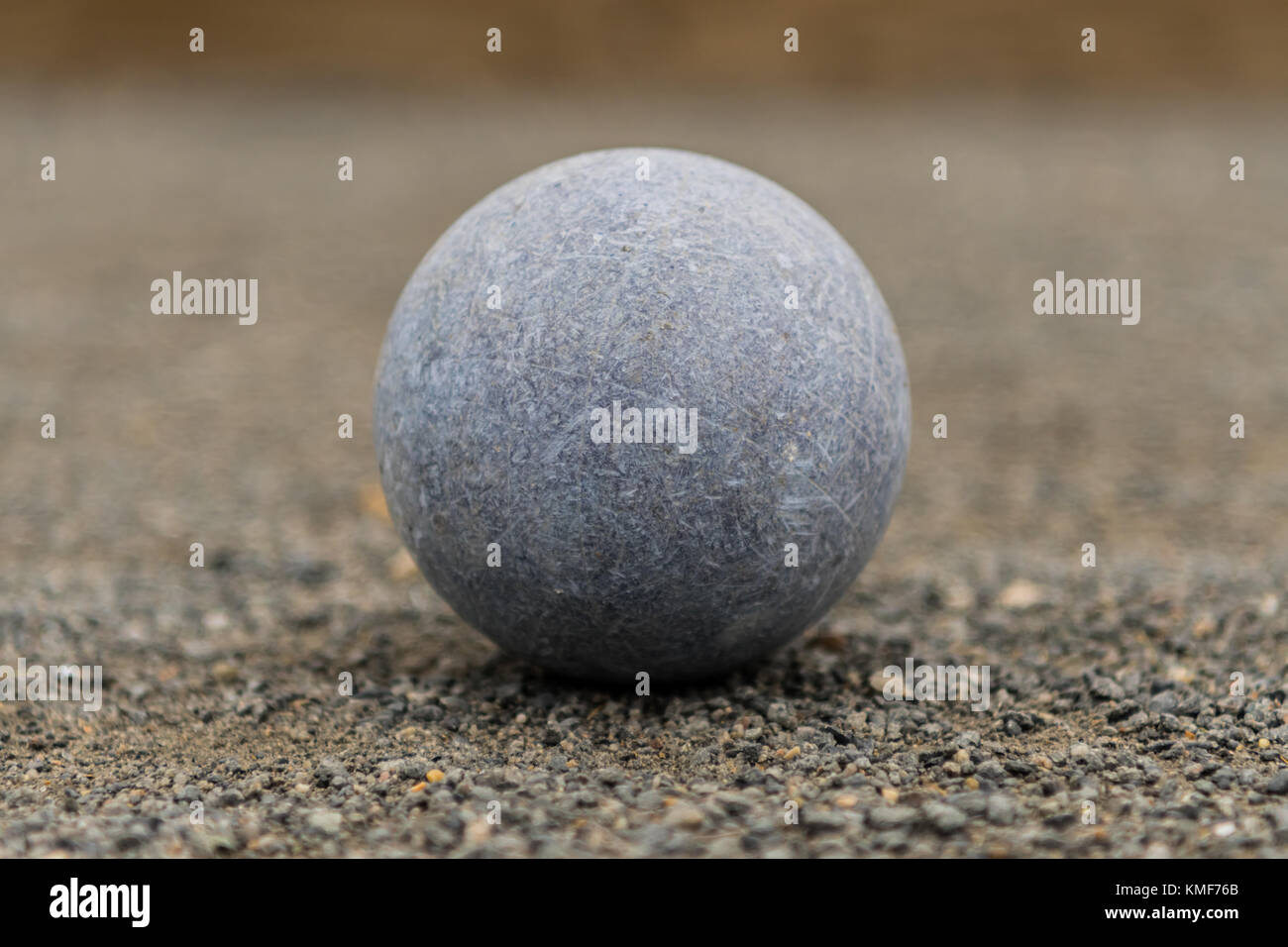 Blue Bocce Ball Centered on fine gravel surface Stock Photo