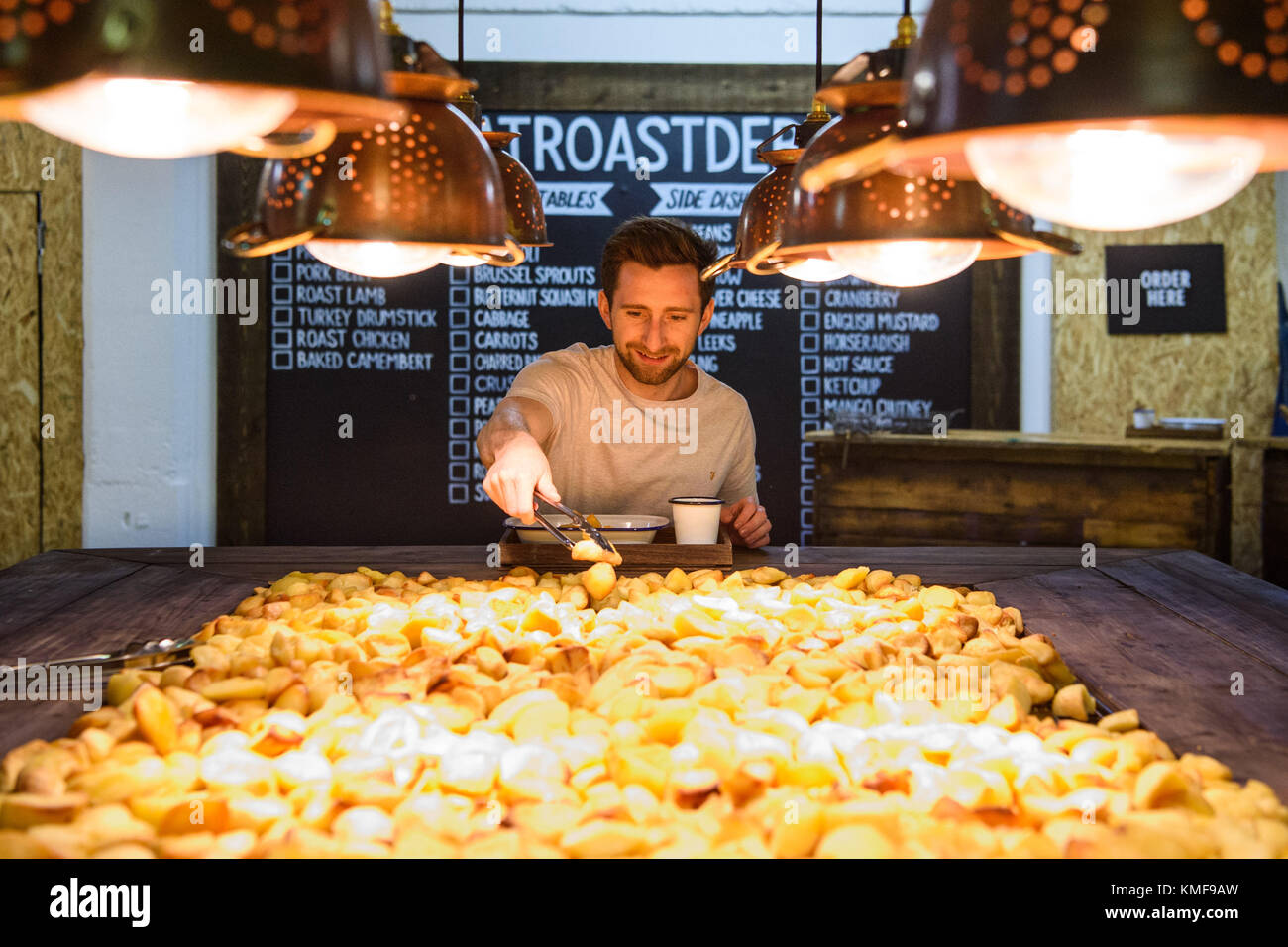 Liam Doolan sampling one of over 100,000 varieties of roast dinner, at the McCain Roastaurant in Shoreditch, east London, Stock Photo
