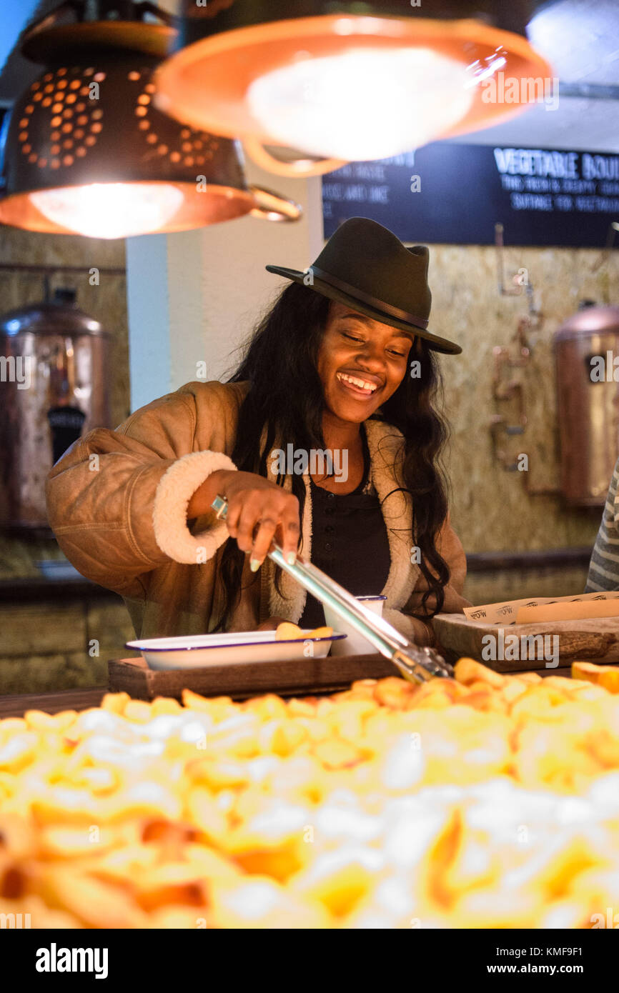 Nana Amaadzie sampling one of over 100,000 varieties of roast dinner, at the McCain Roastaurant in Shoreditch, east London, Stock Photo