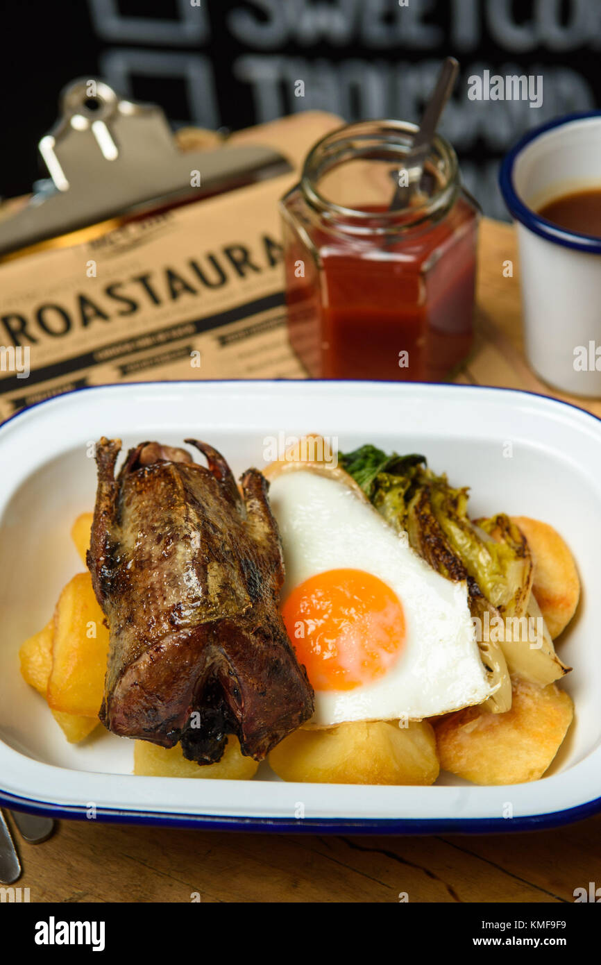 One of over 100,000 varieties of roast dinner, including Pigeon, charred baby gem and a fried egg, at the McCain Roastaurant in Shoreditch, east London, Stock Photo
