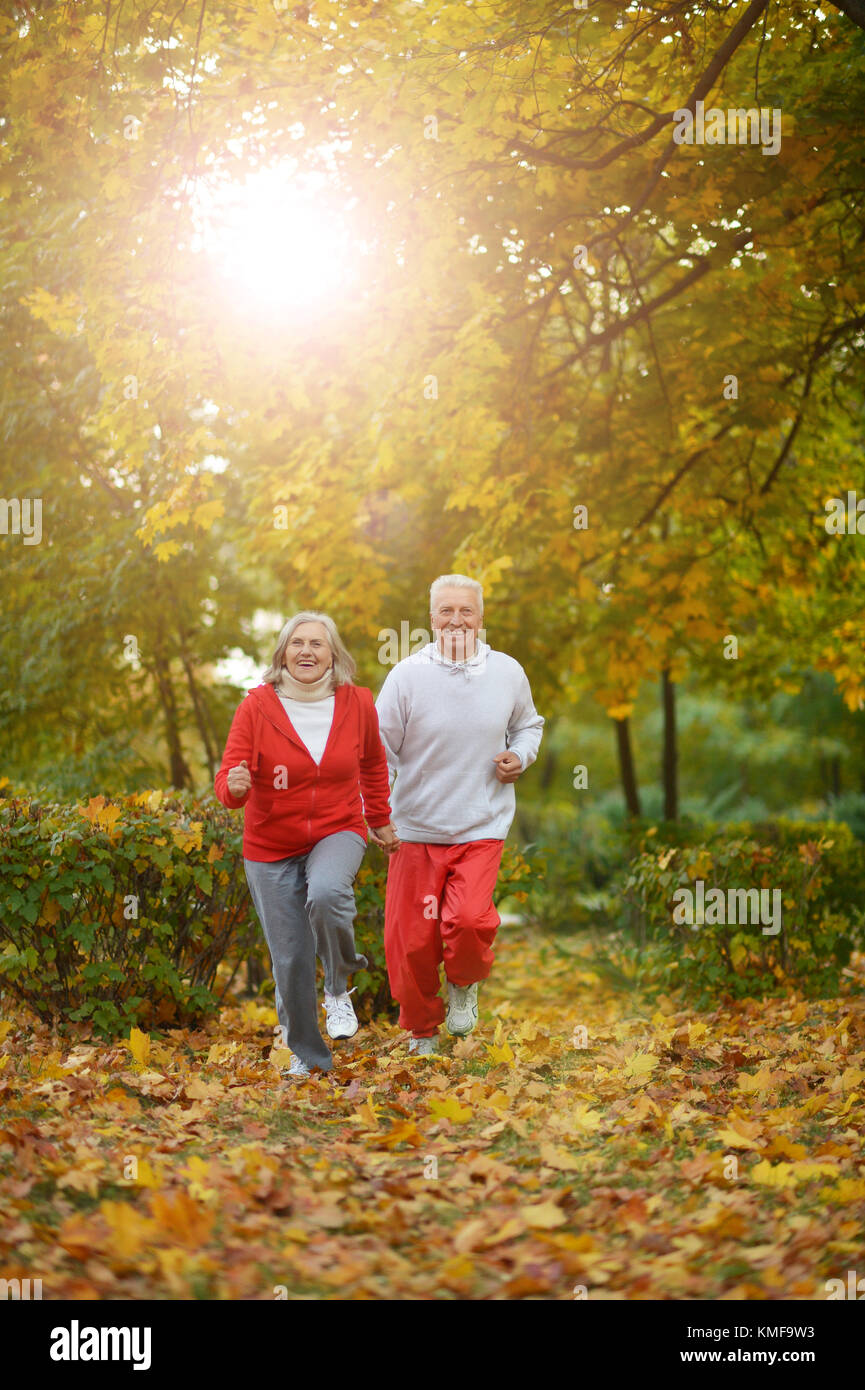 Senior couple jogging in park Stock Photo - Alamy