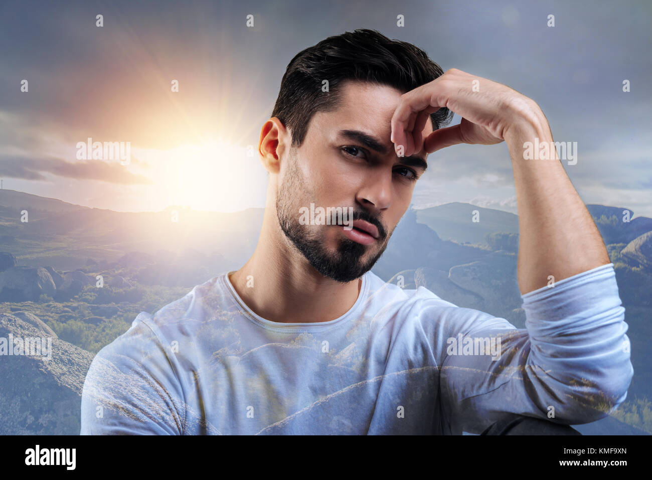 Young creative author sitting and thinking about his next exciting book Stock Photo