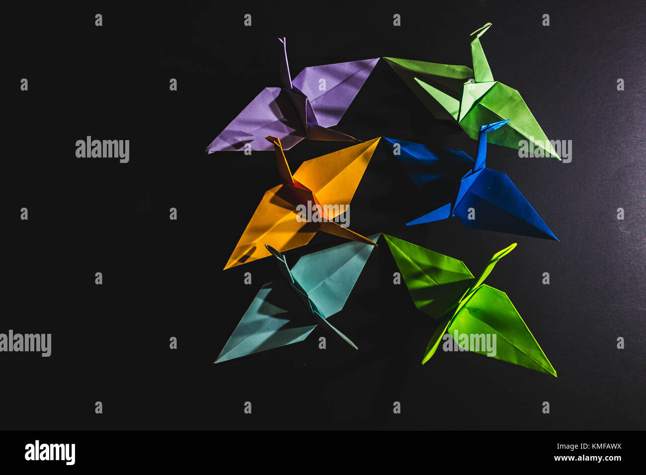 Cranes origami composed of paper of different colors. Cranes are made