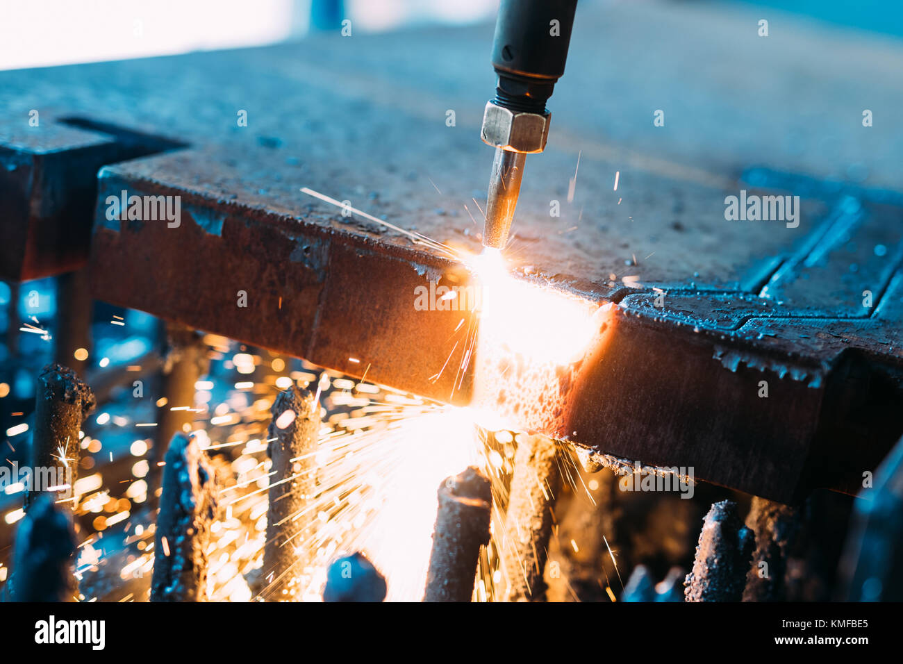 Oxygen torch cuts steel sheet. CNC gas cutting machine. Bright sparks