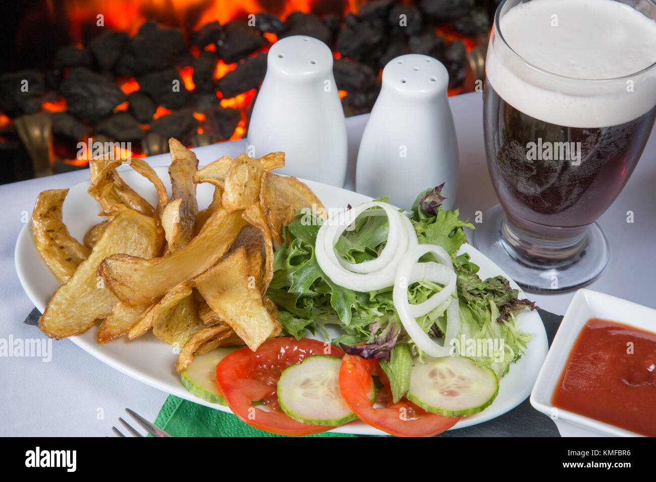 An English pub/restaurant dish of deep fried potato skins with salad