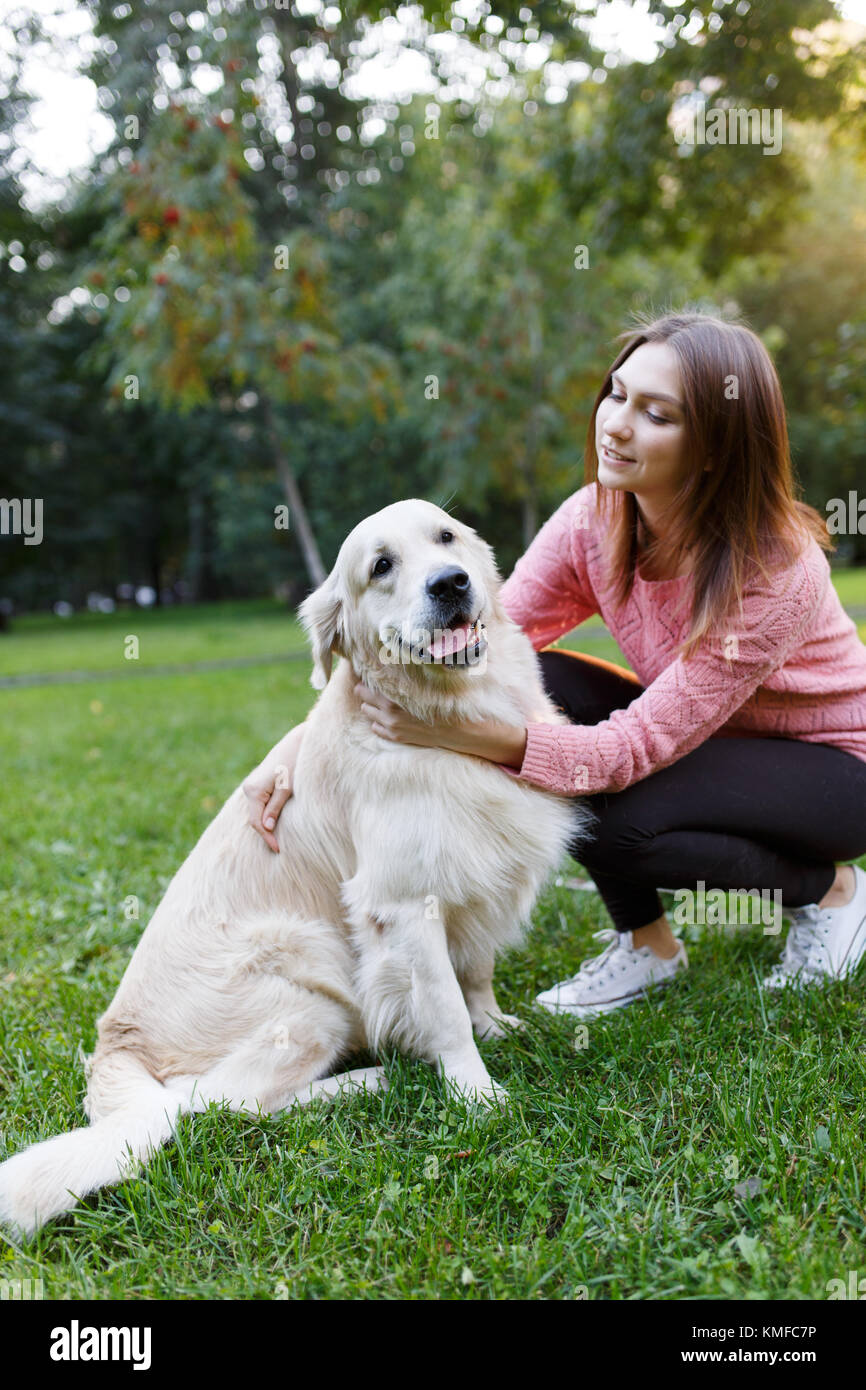 Image of girl with dog on lawn in summer park Stock Photo - Alamy
