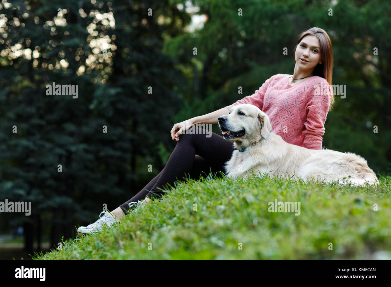 Photo of girl sitting with dog on green lawn in summer day Stock Photo ...