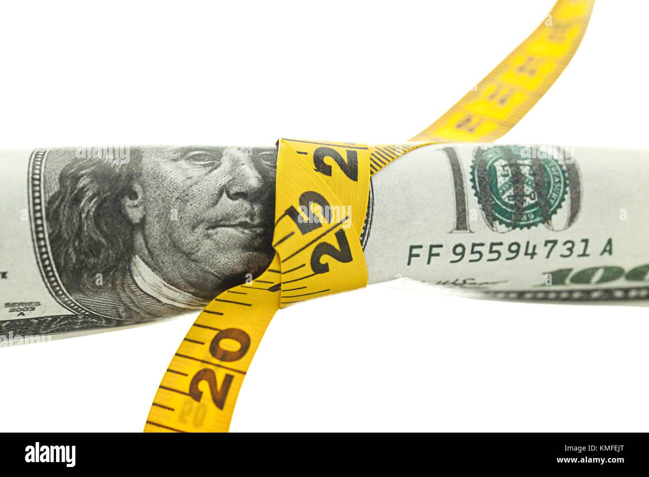dollars roll in the measuring tape Stock Photo Alamy