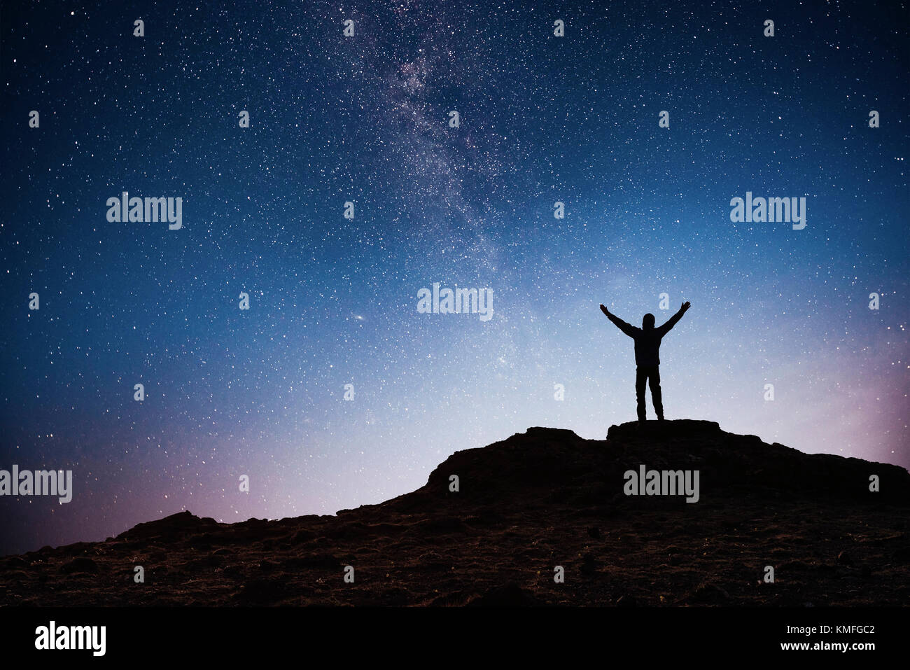 Silhouette young man background of the Milky Way galaxy on a bright star dark sky tone. Stock Photo