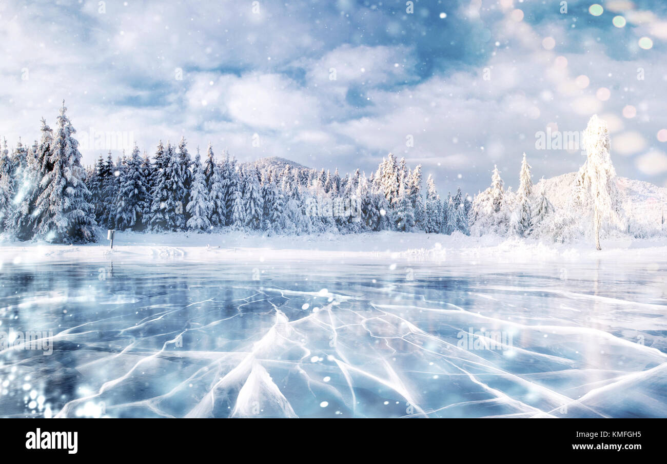 Blue ice and cracks on the surface of the ice. Frozen lake in winter ...