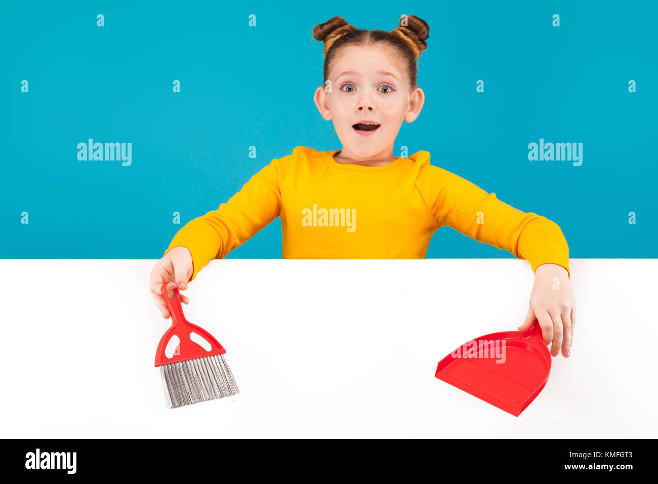 a little pretty girl with dustpan and brush Stock Photo Alamy