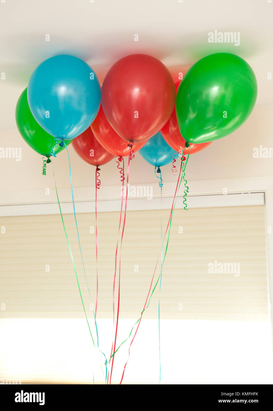 red green and blue bunch of balloons float inside Stock Photo Alamy