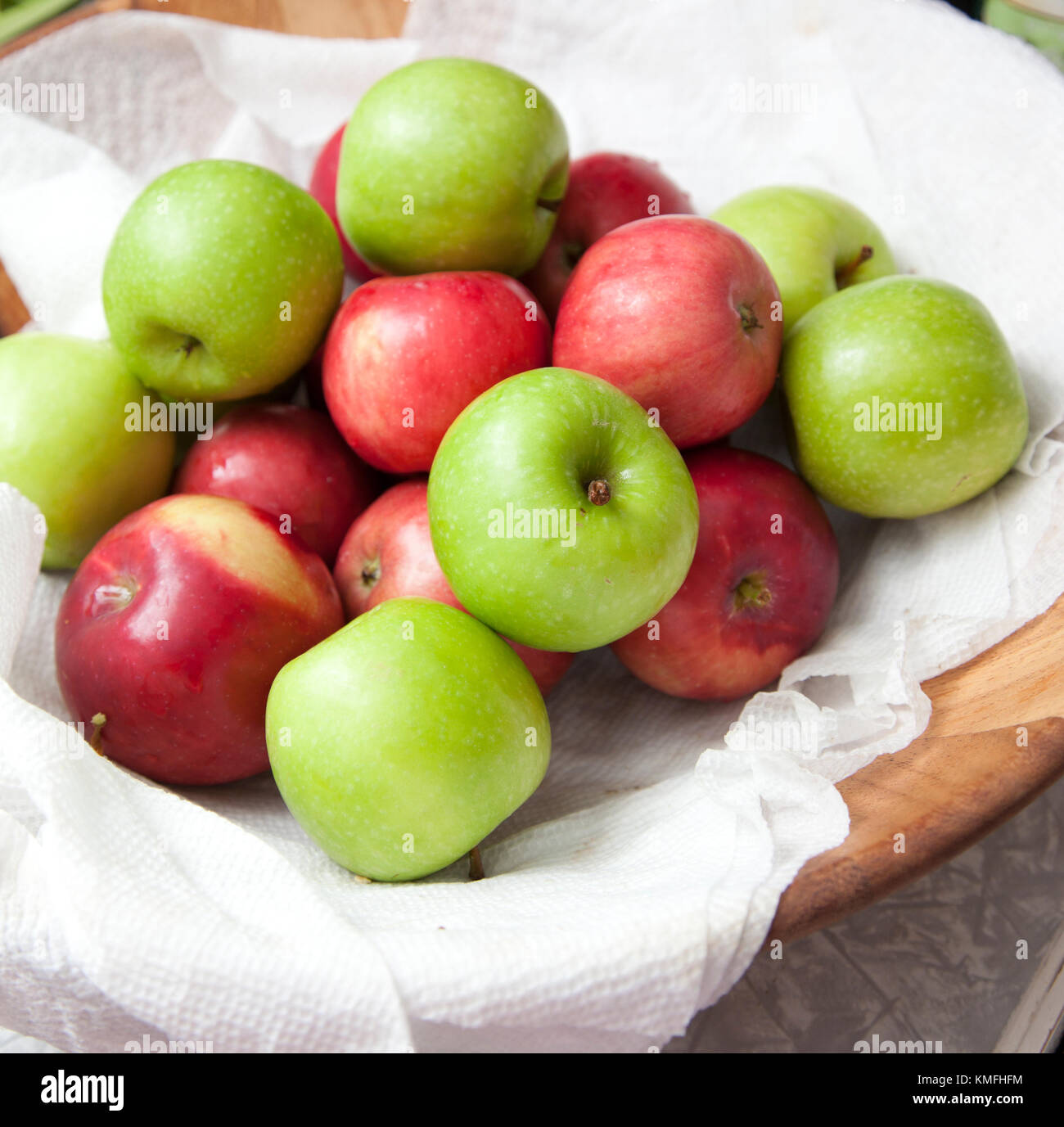 fresh crisp red and green apples in a basket outside at a party Stock Photo