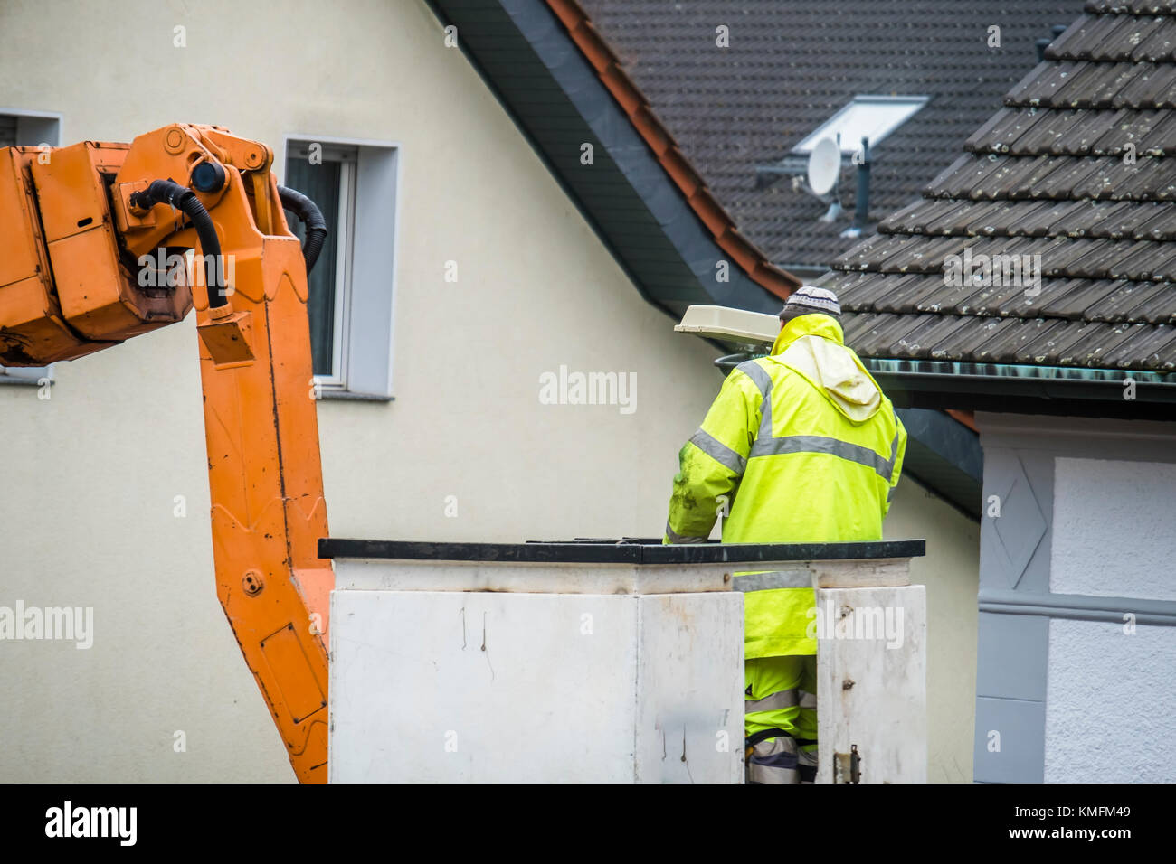Electrician repairing street lights on a lift Stock Photo Alamy