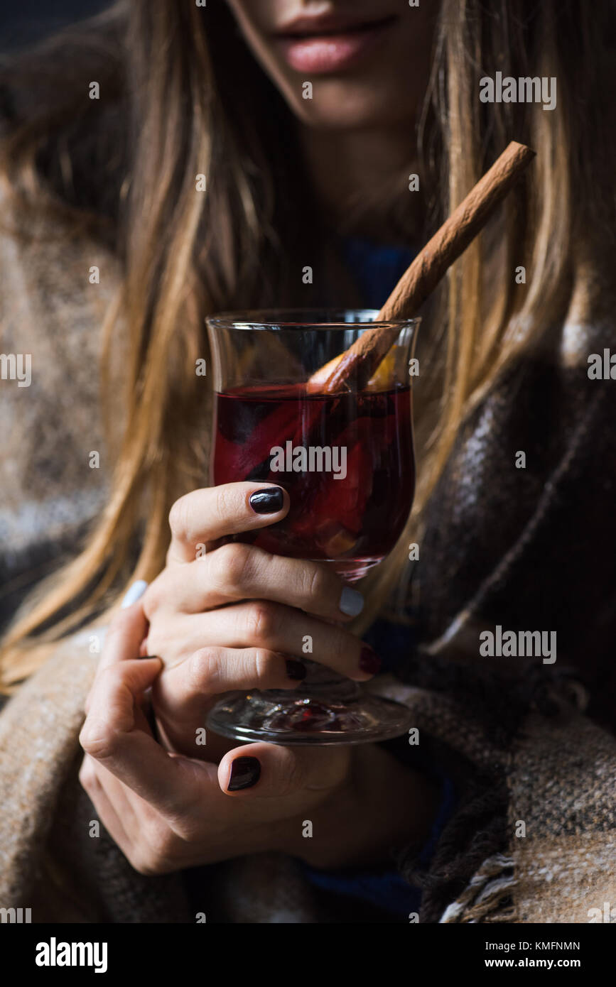 girl holding glass of mulled wine Stock Photo - Alamy