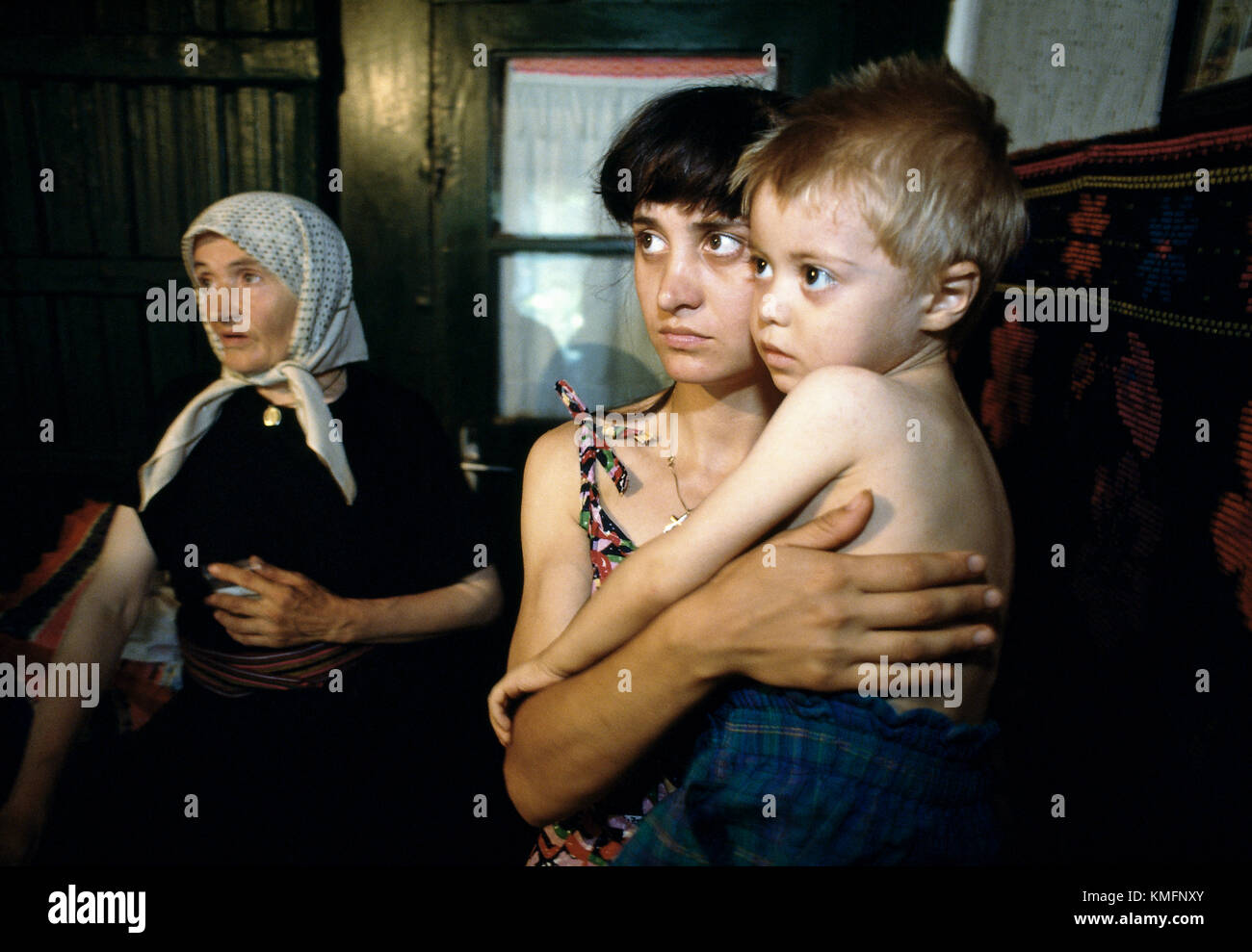 Photograph: John Angerson Romania. Young boy suffering from TB with his Mother and Grandmother during visit by mobile Doctors sent by NGO based in UK. Stock Photo