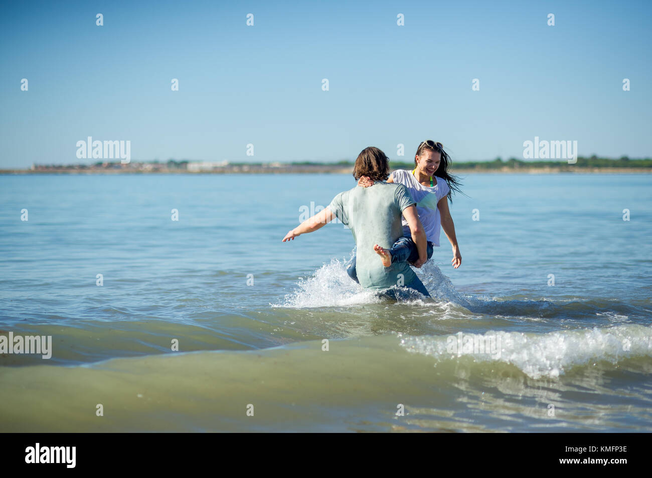 Young couple bathing in the sea. Guy and girl are merrily floundering
