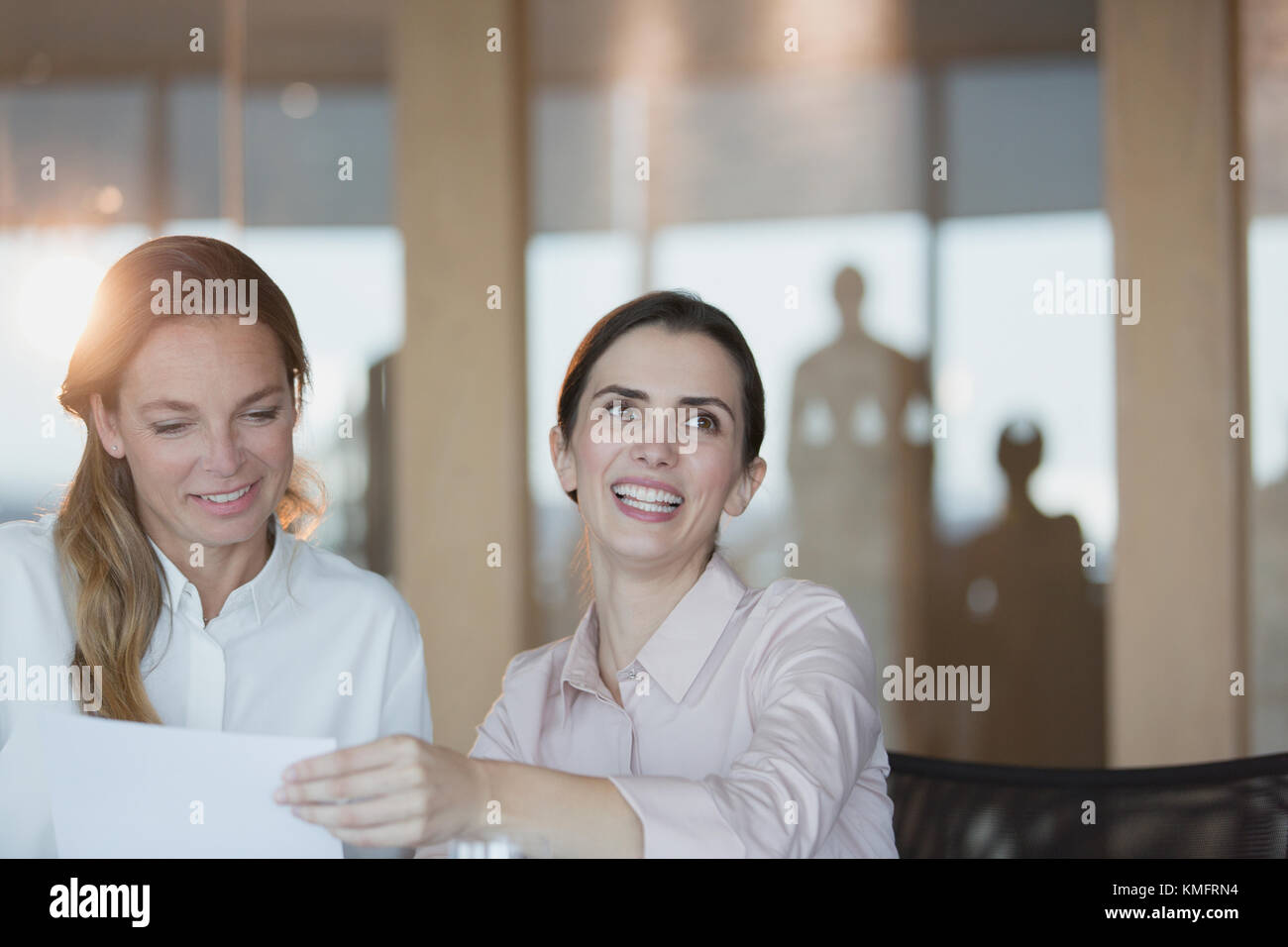 Smiling, enthusiastic businesswoman in conference room meeting Stock Photo