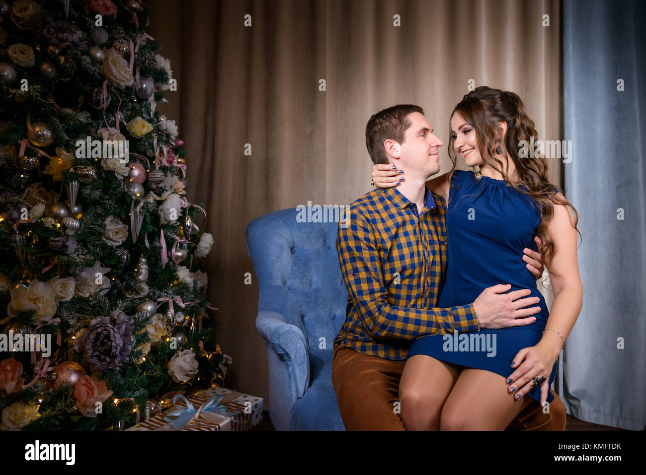 Beautiful young couple in the New Year's atmosphere, photo session in the studio Stock Photo