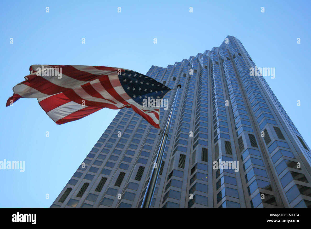 SAN FRANCISCO, CA - AUGUST 2, 2008: American Flag over Skyscraper in San Francisco downtown and sky background Stock Photo