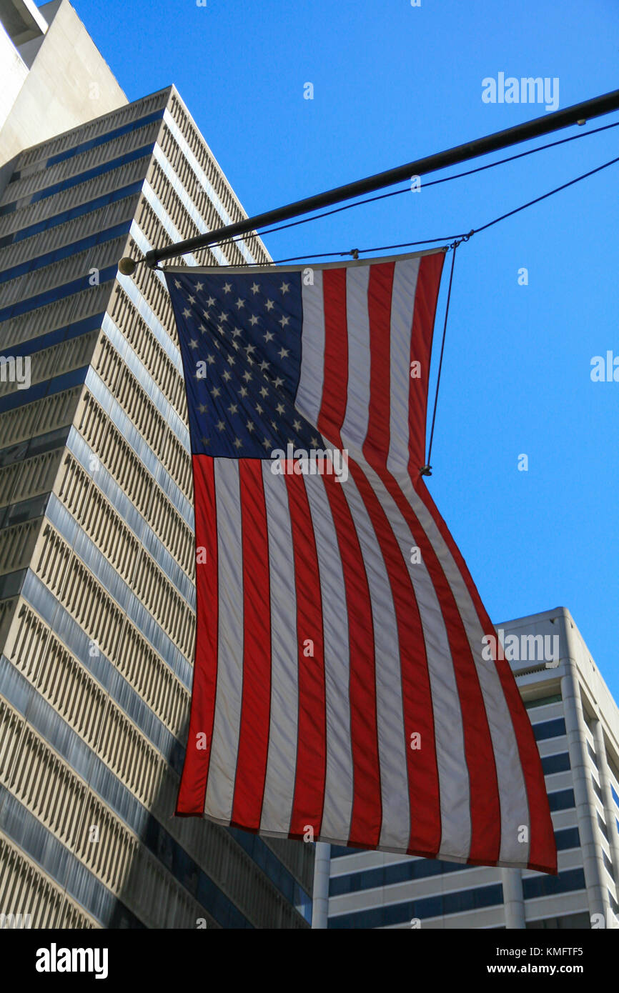American Flag over Skyscraper in San Francisco downtown and sky background Stock Photo