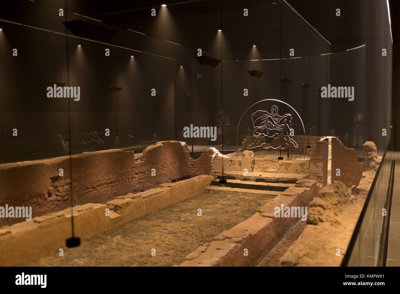 Atmospheric lighting helps display the reconstructed mid-3rd century Roman Mithraeum also known as the Temple of Mithras, Walbrook where bull-sacrifice was practised, now beneath Bloomberg's new European headquarters and open to the public, on 26th November 2017, in the City of London, England. Stock Photo