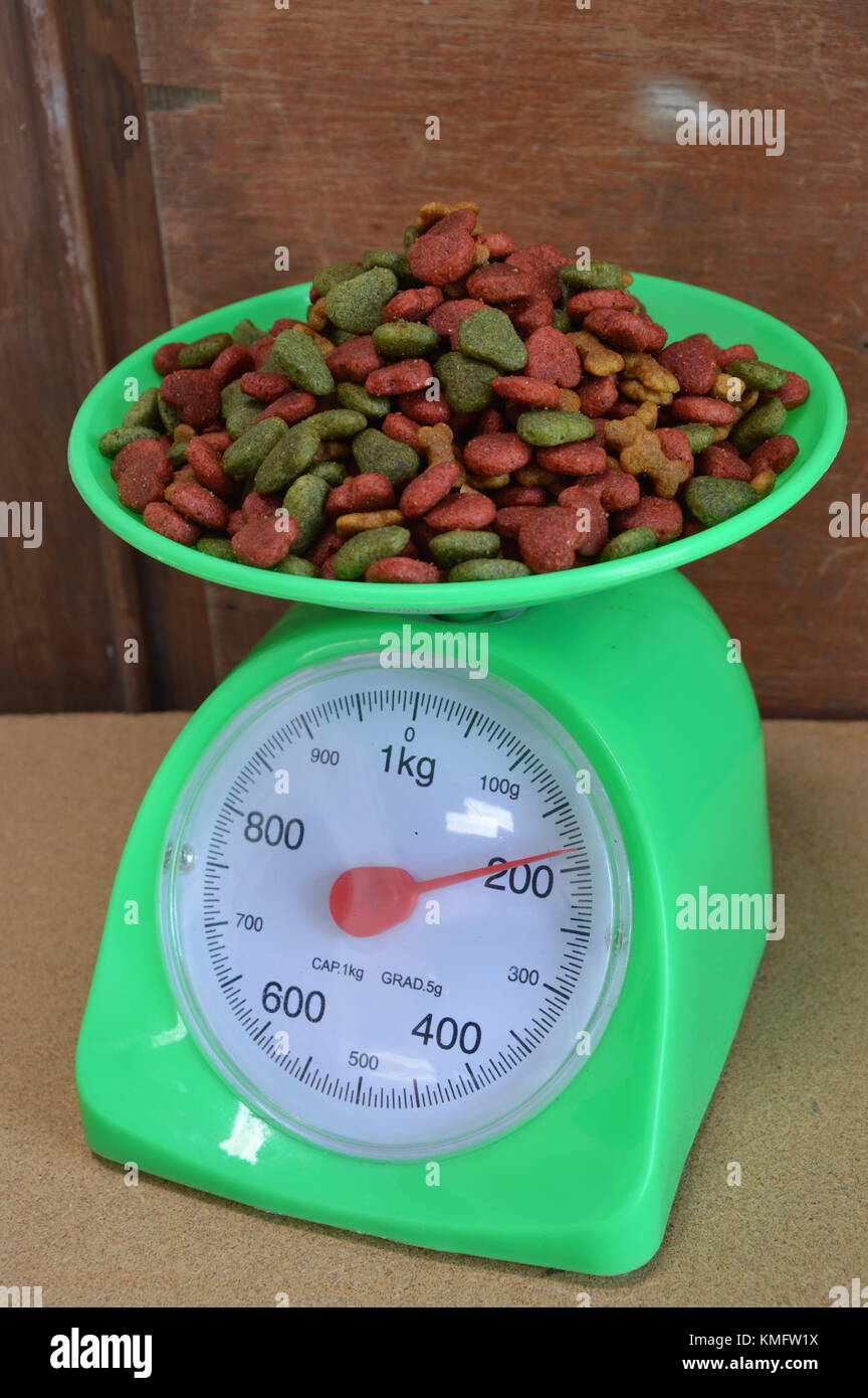 dog food on green weighing scale Stock Photo Alamy