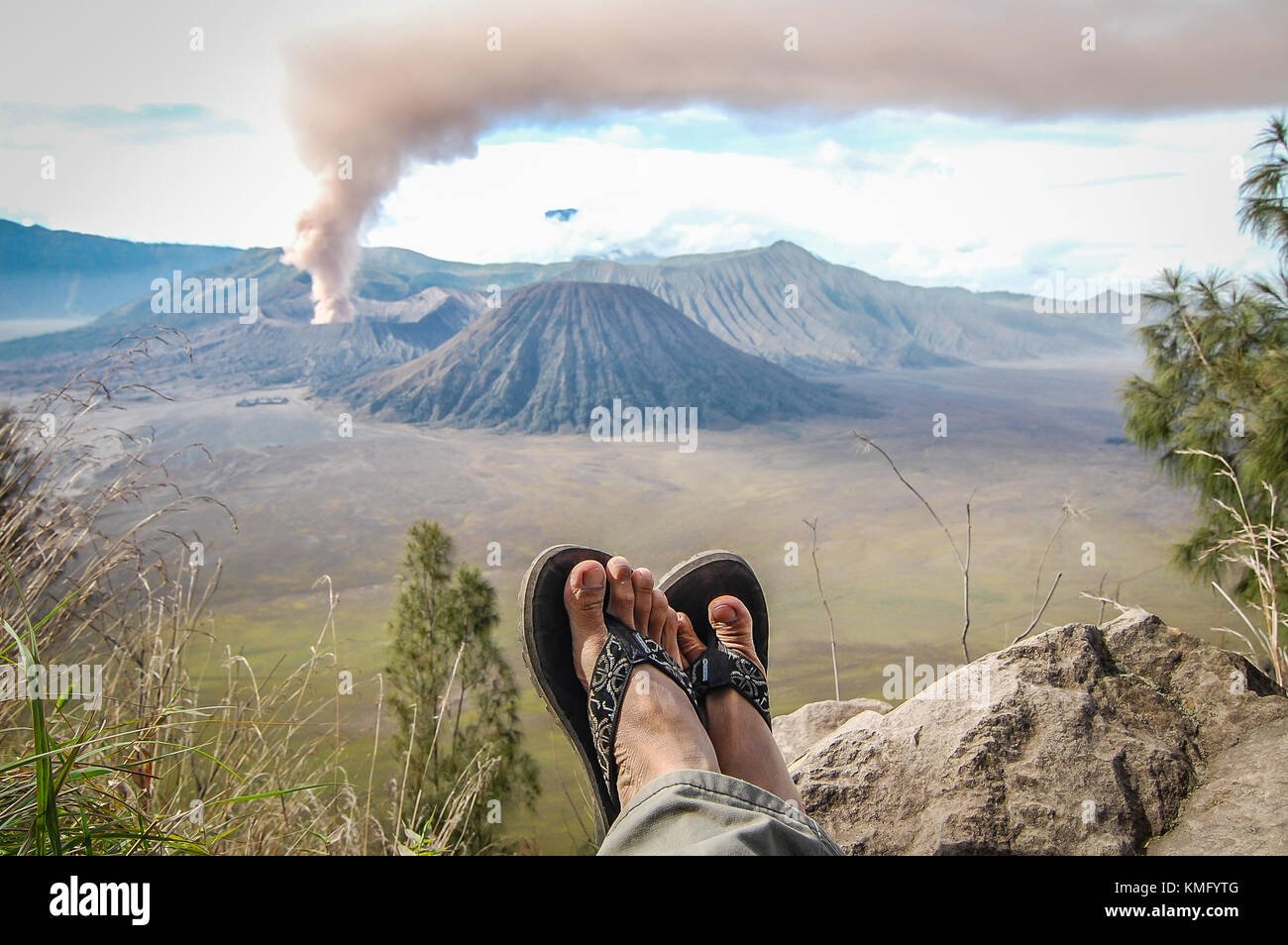 Eruption of mount Bromo and my sendals. Stock Photo