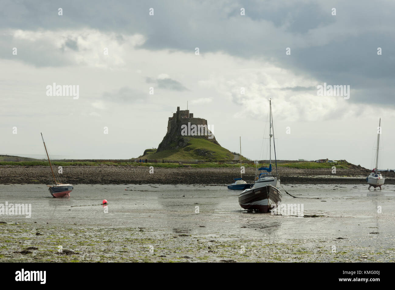 Looking to Lindisfarne Priory, at Holy Island in Northumberland on the North East coast of England, when the tide has receded. Stock Photo