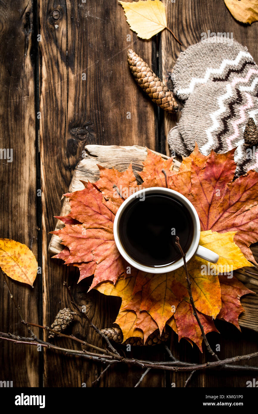 Cup of hot coffee with autumn leaves. On wooden background Stock Photo ...